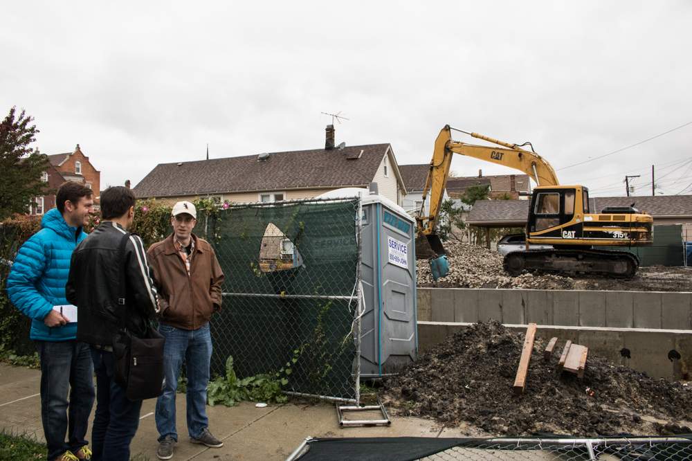 Robert Beedle (right) visited the demolition site that inspired his question alongside Curious City audio producer Jesse Dukes (middle) and City Bureau reporter Jeremy Borden (left). (City Bureau/Manny Ramos)