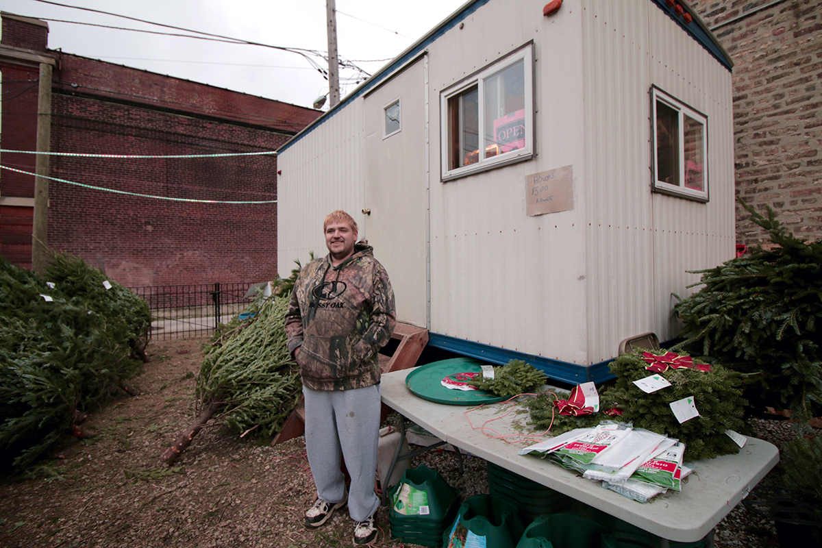 Chris Peterson, 34, of Wisconsin, mans the Arneson Christmas tree lot in Chicago's Old Town neighborhood. He lives in the on-site trailer. 