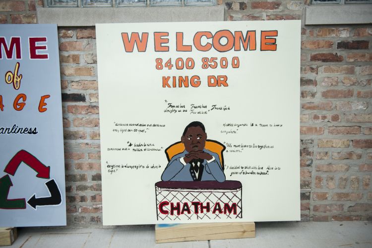 A sign reads "Welcome 8400 8500 King Dr." with a portrait of Dr. Martin Luther King Jr. beneath the orange lettering.