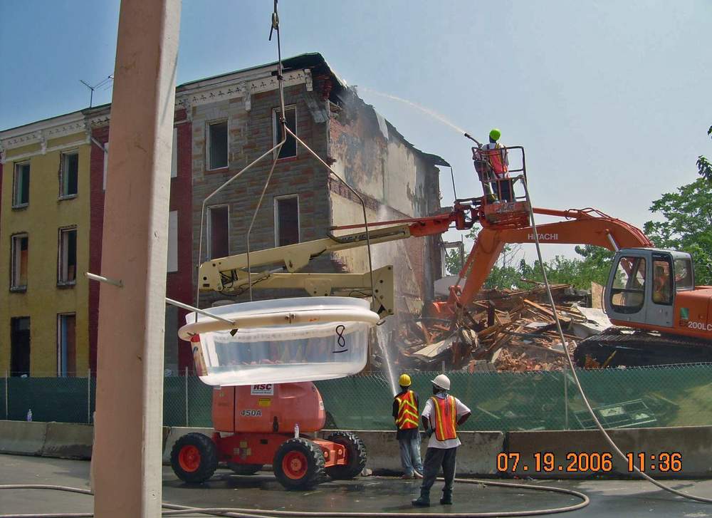 A research team uses a lead dust fall sampling apparatus to measure lead levels in the air during a demolition in Baltimore. (Courtesy David Jacobs)