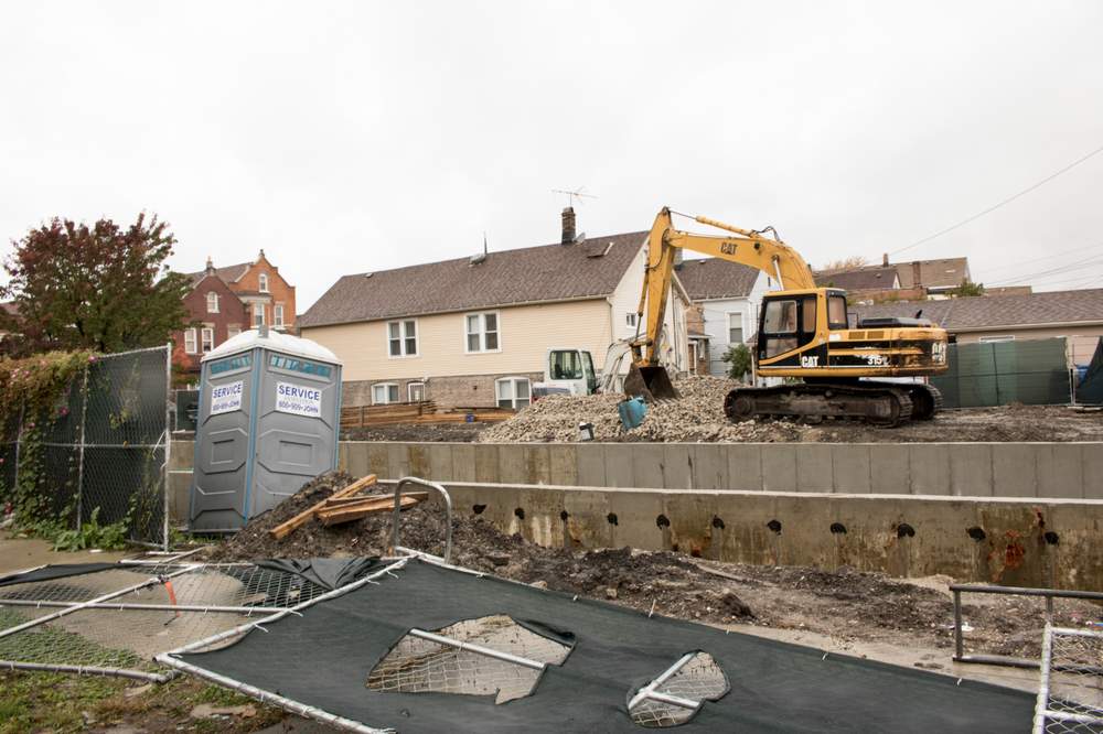 A backhoe lays the foundation for the construction of a new building at the site of the McKinley Park demolition that inspired Robert&#39;s question. (City Bureau\/Manny Ramos)