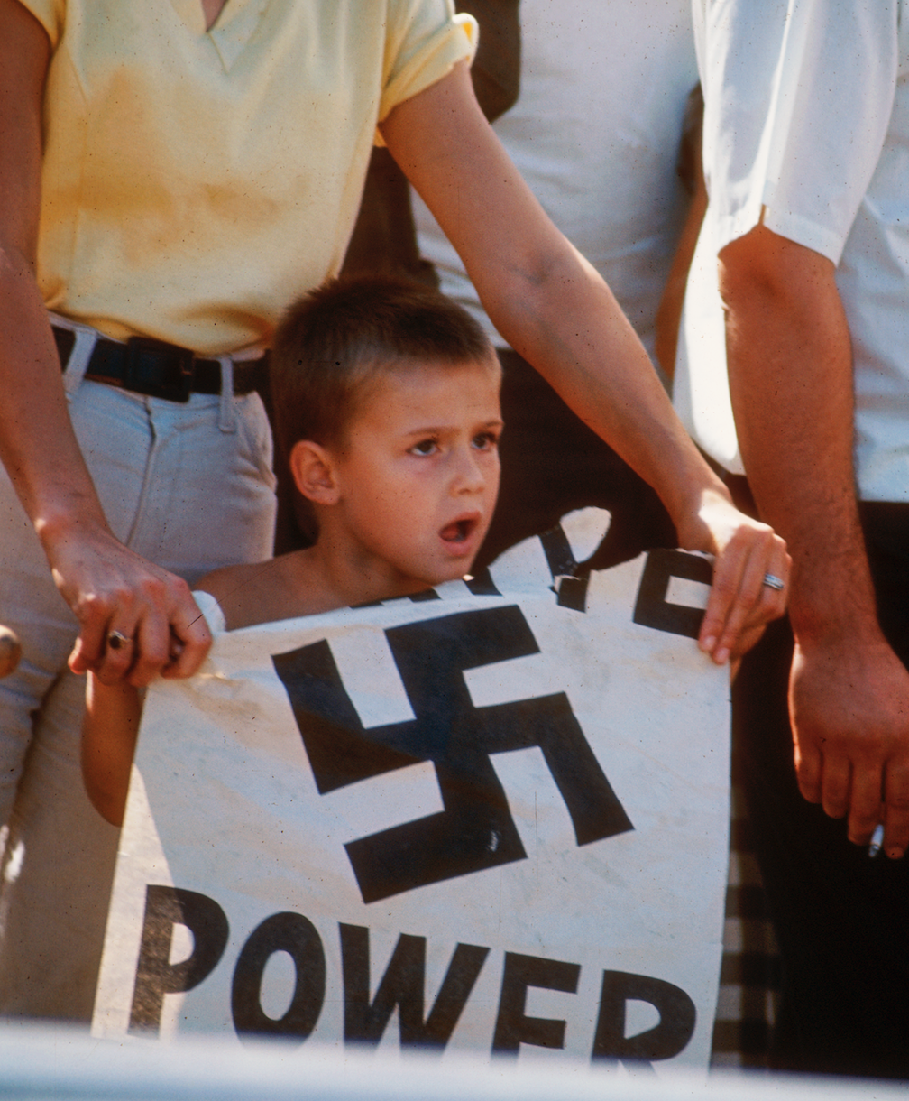 A young boy holds up a “White Power” sign at a counter-demonstration of a civil rights march in 1966. (Courtesy Chicago History Museum, ICHi-036901; Declan Haun, photographer)