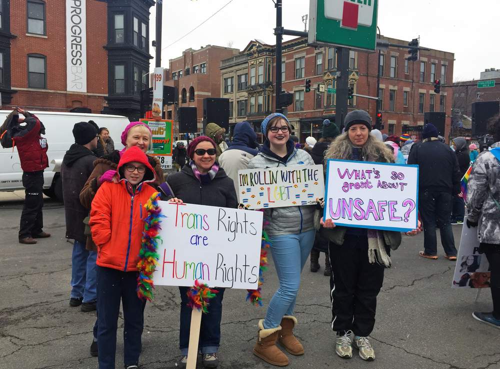 A family holds homemade signs at a transgender rights and awareness march in Boystown in February 2017. (Courtesy Haley Velasco)