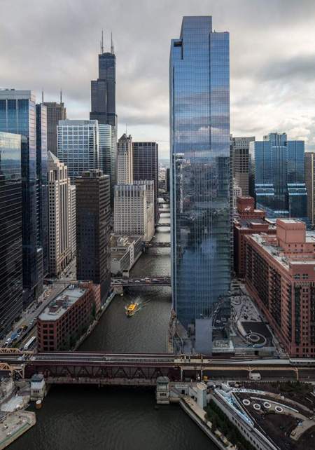 The glistening blue tower at 150 N. Riverside has been called "a building in a park" since it includes a green rooftop plaza and integrates with a new section of the Riverwalk. (Courtesy of Goettsch Partners)