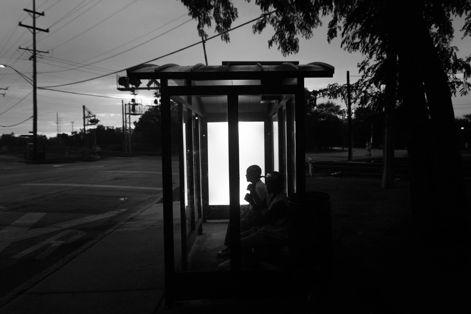 Two residents wait at a Dolton bus stop on their way to downtown Chicago. Taking public transit can be difficult in the south suburbs, with waits for Pace buses often lasting 30 to 50 minutes and commutes to the city taking more than an hour.