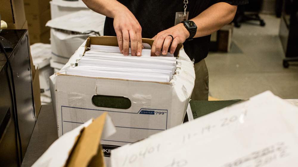 John Lorenz organizes gun receipts at the ATF National Tracing Center in Martinsburg, W. Va. (Raymond Thompson Jr. for WBEZ)