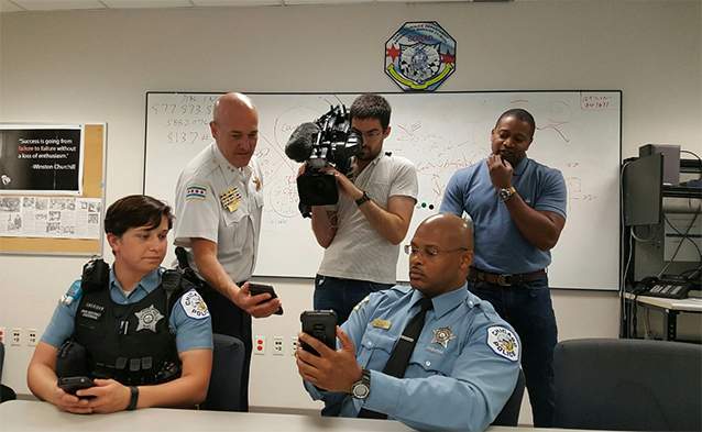 Chicago police officers show off smartphones that can receive information from ShotSpotter. (Courtesy of CPD)