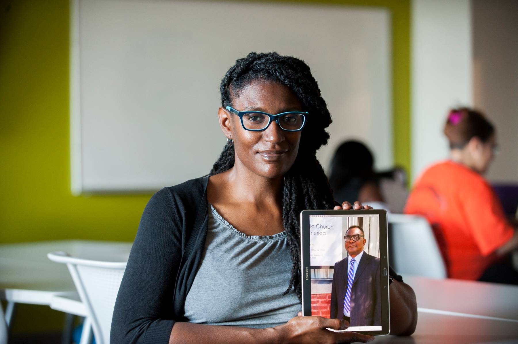Ericka Mingo holds an iPad with a photo of her student Ndueso Odoiwod